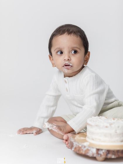 A messy and happy baby after a successful cake smash.