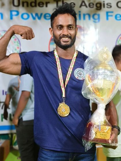 My student crowned Senior Strongman in Deadlift at the National Championship. He holds the trophy and medal that prove his power.