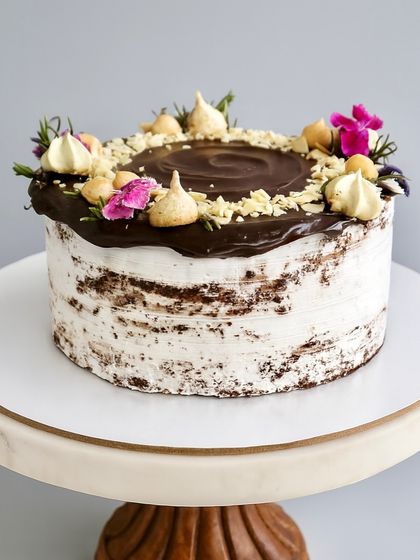For those who like their cake bold and nutty, my Chocolate Hazelnut Naked Cake is unforgettable. It features a decadent chocolate sponge, dark chocolate ganache, Nutella, and a topping of roasted hazelnuts and almonds.