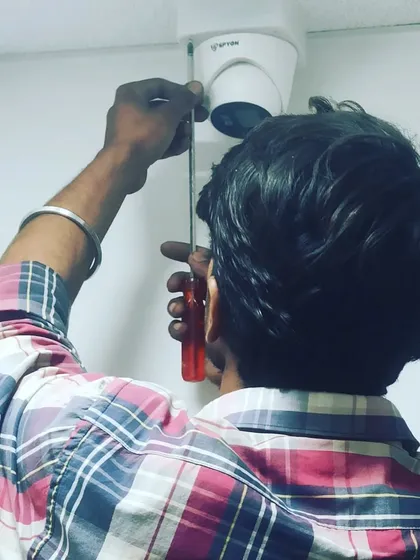 I pay close attention to every detail during installation and repair. Here, I am securing a CP Plus dome camera to the ceiling, ensuring a solid fitting for long-lasting security.