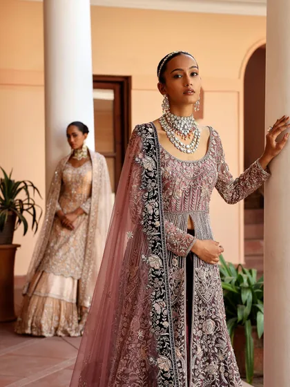 This image showcases my work in opulent occasion wear. I focused on layering textures and intricate embroidery, styling two complementary gowns to create a vision of grandeur suitable for a luxury wedding reception or red carpet appearance.