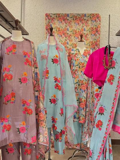 A full display of the dreamy floral collection, featuring kurtas and a saree in soft, romantic prints.