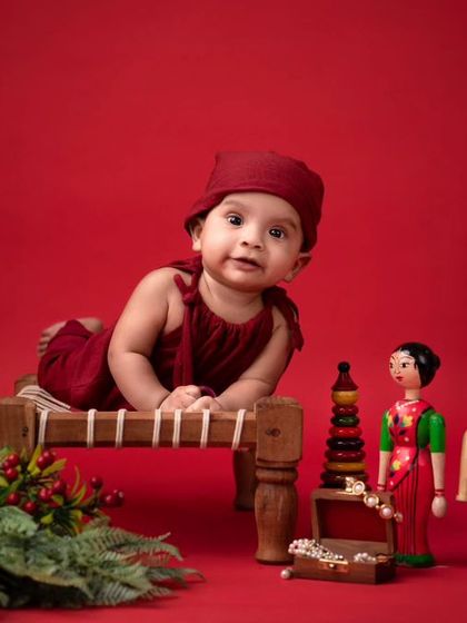 A beautiful composition featuring classic Channapatna toys. This traditional setup is perfect for milestone sessions like a half-birthday or sitter shoot.