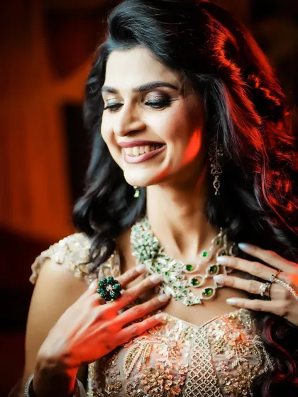 A beautiful portrait of the bride admiring her stunning necklace.