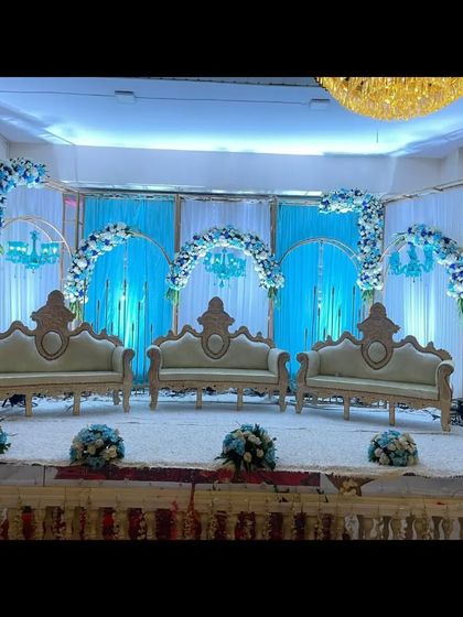 A stunning blue and white themed stage decoration at Palm Beach banquet. The multiple arches and matching floral arrangements create a cohesive and visually striking design.