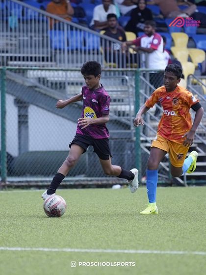A young player shows great speed and control while running with the ball.