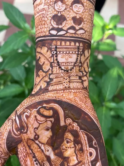 A close-up of the Raghavendra Swamy Vrindavan and meditating couple figures. This part of the design reflects the couple's spiritual journey together.