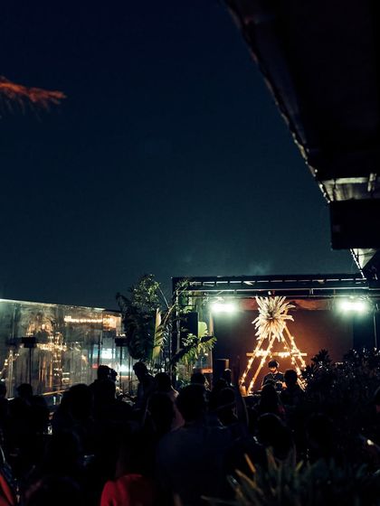 A promotional image for an "Aurum Night" at Xora Hyderabad. The poster highlights the multi-faceted experience, including a celebrity bartender and DJ, to attract a crowd looking for a glamorous night out.