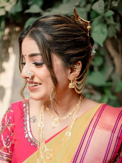 A side profile of Shreya, showing her modern Maharashtrian hairstyle with highlights and traditional ear chains (kaan vel).