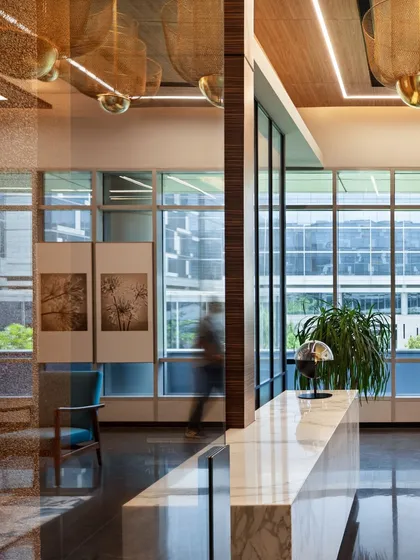 Another view of the APT office, showcasing the elegant reception area where a marble desk and contemporary lighting create a sophisticated first impression.