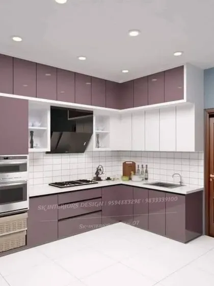 A modular kitchen design with a striking combination of purple and white cabinets. The layout includes a tall unit for built-in ovens and practical wicker baskets for storage.