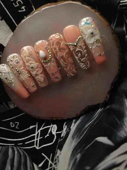 For the bride who wants to feel like royalty, I create these incredibly detailed nail sets. This design features intricate white patterns, 3D floral elements, and carefully placed gems for a truly luxurious and unforgettable bridal manicure.