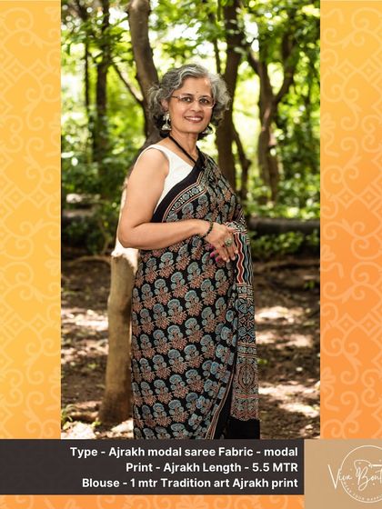 A classic black Ajrakh modal saree with intricate floral and geometric block prints. This versatile piece can be dressed up or down, making it a wonderful addition to any wardrobe.