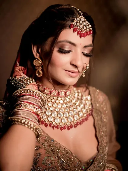 The details of her makeup and jewelry come together to create a look that is pure regalia.