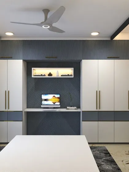 This master bedroom design includes wardrobes on either side of a central study or vanity unit. The dark blue accent wall and gold handles add a touch of luxury.