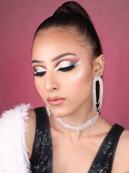 Feast your eyes on this stunning creativity. A dramatic graphic liner look with a silver cut crease and a high ponytail, perfect for a fashion editorial.