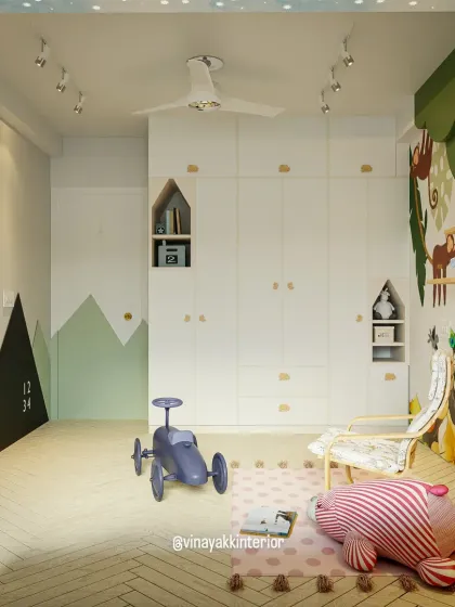 This angle shows the full scope of the room, including the whimsical wall mural featuring little Krishna and playful monkeys. The design combines practical storage with imaginative decor, like the tree-shaped bookshelf, to create a complete dreamland.