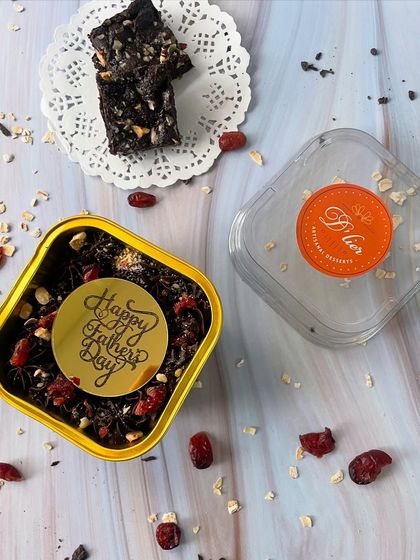 A "Happy Father's Day" sticker adorns this tin of our healthy oat brownies, topped with cranberries and nuts.