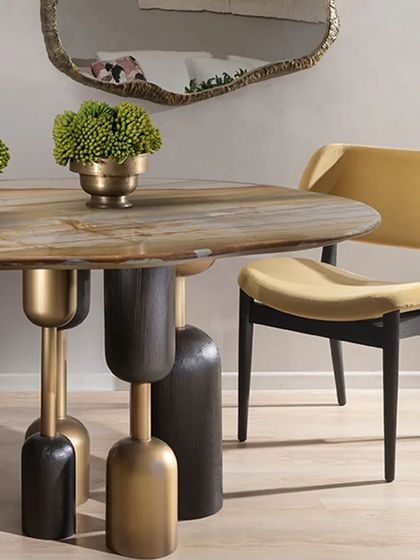 Our Lotus Quartz dining table paired with an elegant, armless dining chair. The chair's simple form and luxurious velvet upholstery complement the table's bold design, creating a balanced and sophisticated dining setting.