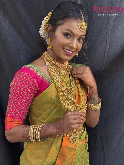 A happy bride showcasing her complete traditional South Indian look, a testament to the skills our students acquire.