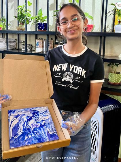 The stunning blue and white patterns on this canvas show how different color combinations can create completely different moods in fluid art.