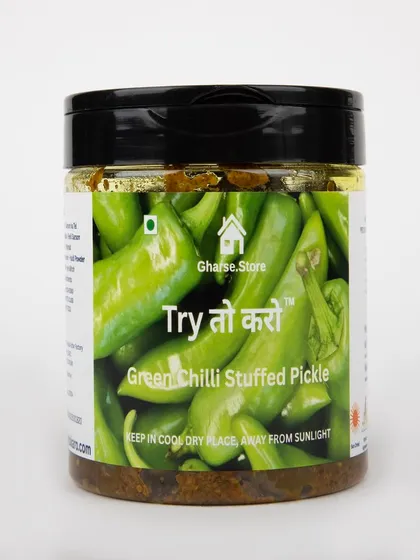 A jar of Green Chilli Stuffed Pickle on a white background.