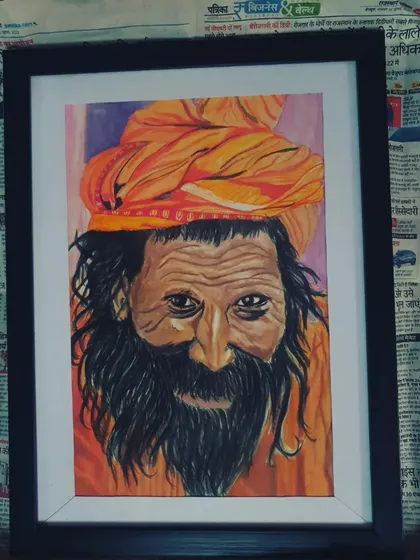 The framed acrylic portrait of the sadhu, highlighting the vibrant orange of his turban and the rich details.