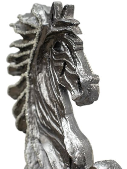 A close-up view of the head of "The Rising Horse," showing the intricate textures and embedded diamonds that give it life.