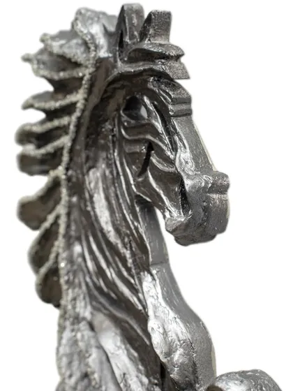 A close-up view of the head of "The Rising Horse," showing the intricate textures and embedded diamonds that give it life.