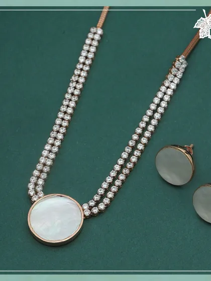 Inspired by the serene glow of the moon. The Moonlight Shell set from our Zira collection features iridescent mother of pearl paired with sparkling diamonds, creating a piece of tranquil and sophisticated beauty.