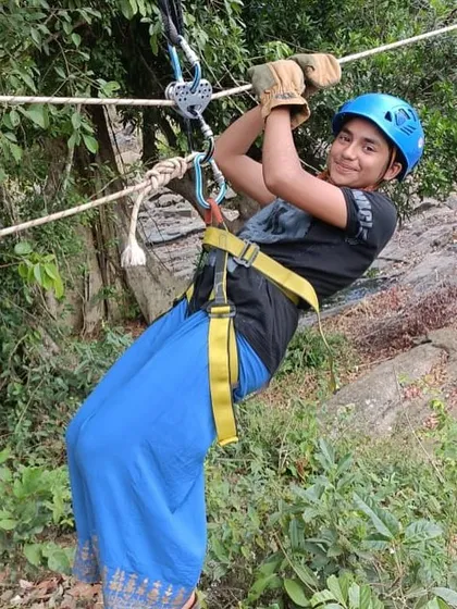 A smiling camper enjoys the zipline, a popular activity at our Barapole adventure camp.