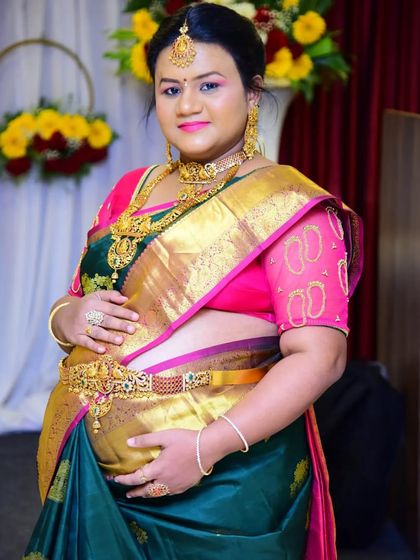 Lavanya looking radiant for her seemantha. The makeup features a bright lip and defined eyes, paired perfectly with her gold jewellery.