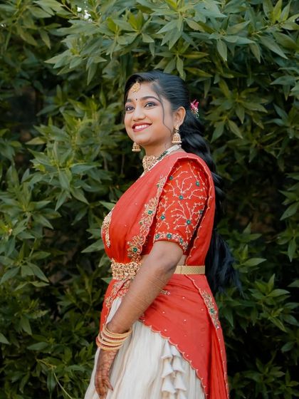Radiant and glowing! My cherished client Harshitha dazzles on her engagement day in this custom-made red and ivory half saree that I crafted for her in under a week. She looks absolutely stunning.