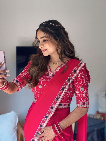 Bride Anjali, looking radiant for her Mayra ceremony. The red saree and soft makeup create a look that is both traditional and fresh.