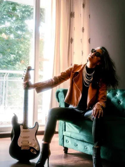 Here, I'm channeling my inner rock star. This edgy look, complete with a biker jacket and an electric guitar, shows my ability to embody a completely different persona for brands looking for a bold, rock and roll vibe.