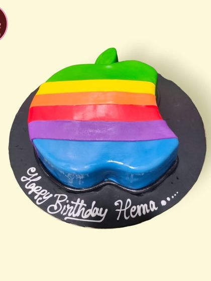 A colorful cake shaped like the retro Apple logo. This is a fun and creative design for a tech lover or an Apple enthusiast.