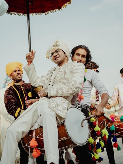 The groom enjoying the dhol beats during his energetic baraat.