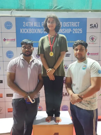 A female athlete from our academy receives her gold medal at the Faridabad District Championship. We train our athletes to compete and win at every level.