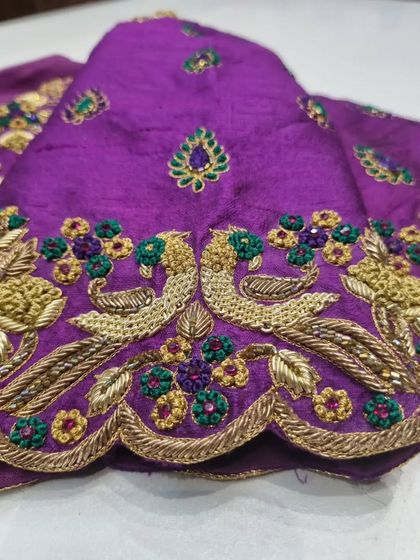 A detailed view of the peacock motifs on a purple blouse sleeve. I use gold zardosi and multi-colored threads to create these classic symbols of Indian bridal wear.