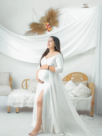 This portrait is all about softness and light. Set in my bright, airy studio, the mother-to-be in a flowing white gown looks serene and angelic, capturing the pure, hopeful feeling of this special time.
