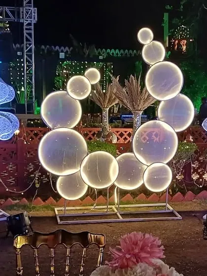 Custom-made light-up props like these bubble circles and flowers can add a whimsical and futuristic feel to any party or sangeet night.