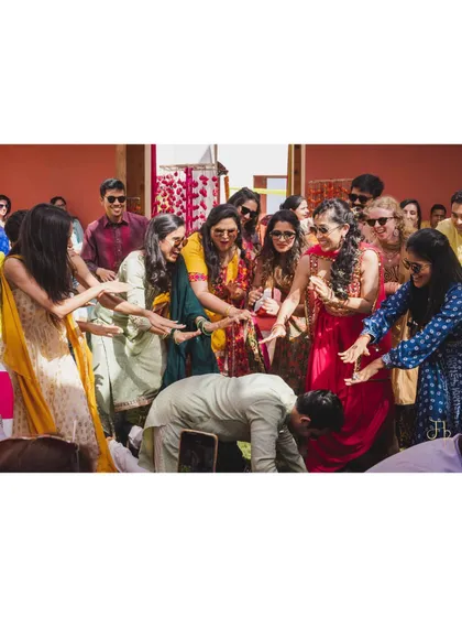 A playful moment captured during the group dance where the bride's squad showers the groom with love. It’s these fun interactions within the choreography that create lasting, happy memories.