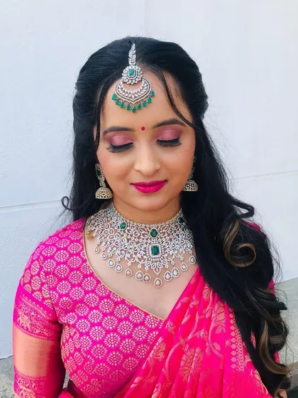 A close-up look at the details of this pre-wedding makeup. I created a soft pink eyeshadow look to complement the client's vibrant pink lehenga, paired with flawless skin and a matching lip color for a fresh and youthful glow.