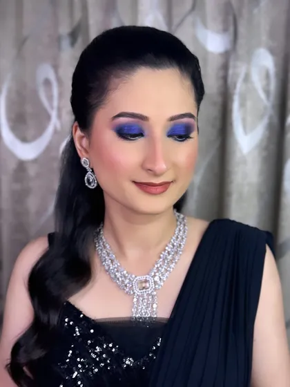 A detailed shot of the electric blue smokey eye. The vibrant color is blended seamlessly to create a dramatic yet sophisticated look for an evening party.