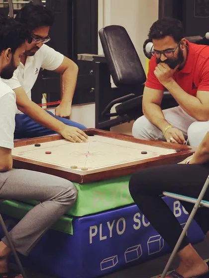 Taking a short break for a game of carrom. We believe that finding moments for play and relaxation helps our team stay energized and focused.