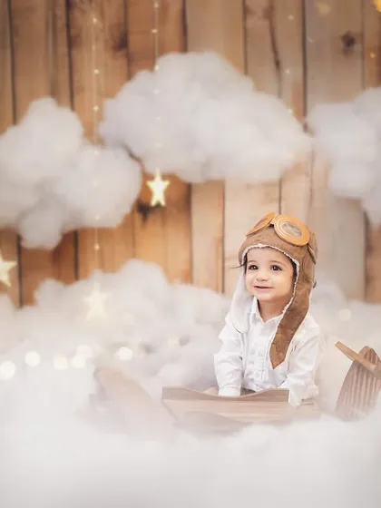 A sweet, curious glance from our birthday boy in his pilot gear. These themed sessions are designed to be fun and engaging for the baby, allowing me to capture their natural expressions.