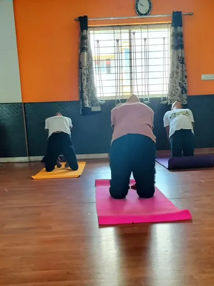 Students in Ustrasana (Camel Pose), a deep backbend that opens the heart chakra.