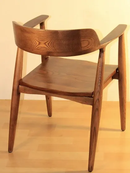 A dining chair I am particularly proud of, inspired by classic mid-century modern design. Made from solid teak wood with a beautiful grain and finished with a melamine polish, this chair is both a functional seat and a piece of art.