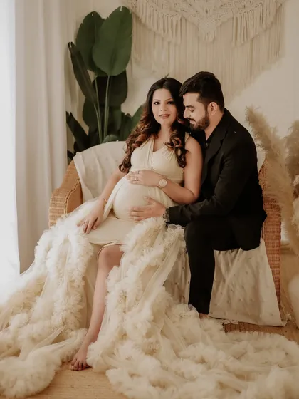 Our boho-themed setup is perfect for a relaxed and stylish maternity session. This couple's portrait features natural textures like wicker and macrame, creating a warm and inviting atmosphere.