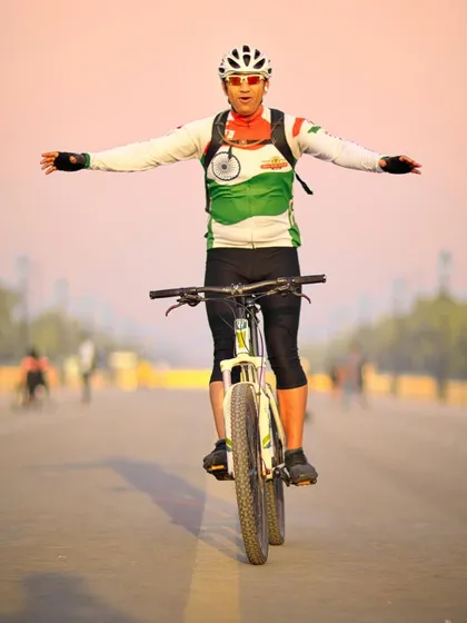 Feeling unstoppable on the open roads of Delhi. A cyclist celebrating the freedom of the ride with Rashtrapati Bhavan in the background.